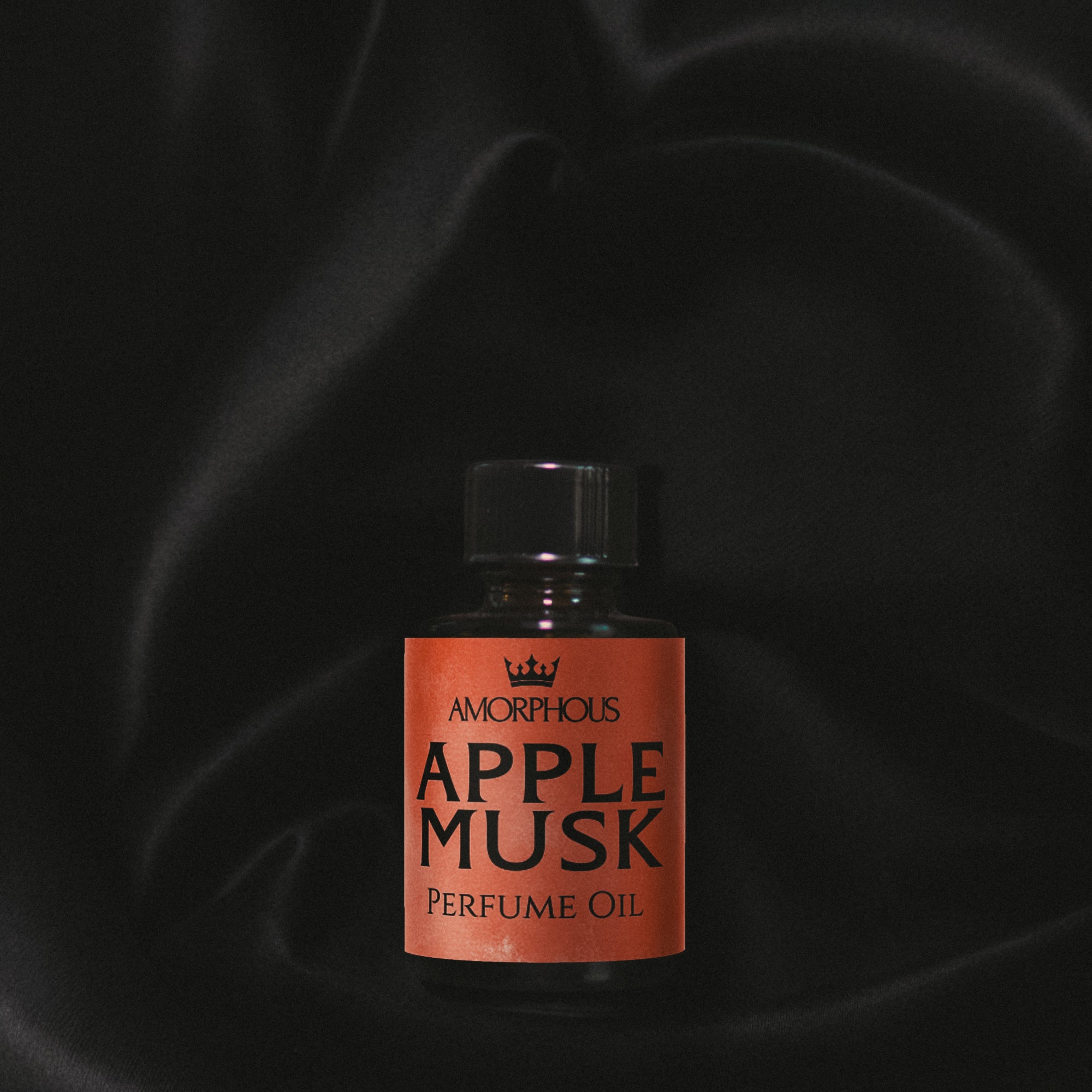 Bottle of Apple Musk perfume oil with a dark background