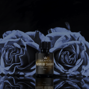 Perfume oil bottle labeled 'Circus' on a dark background with blue roses.