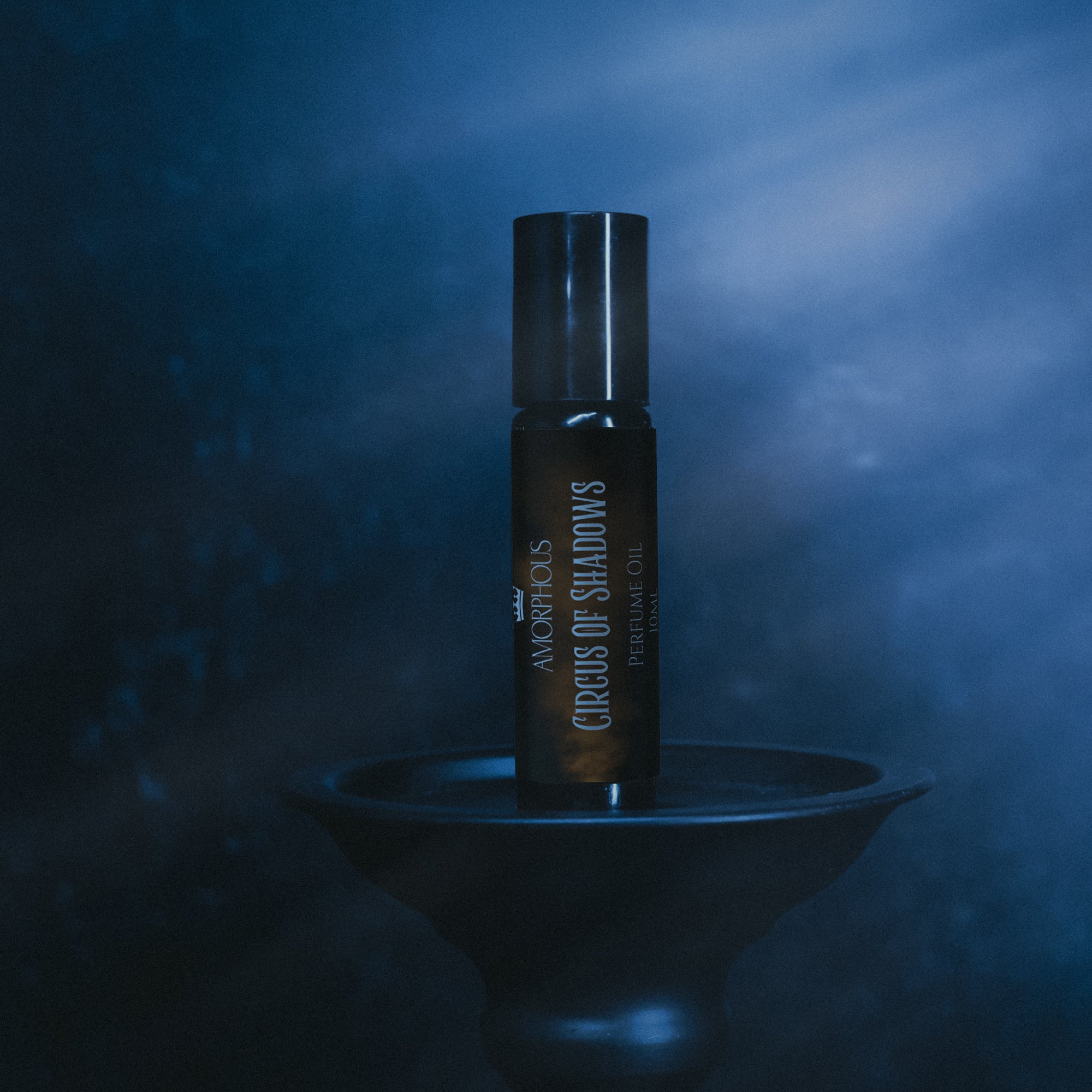 Perfume bottle labeled 'Circuses of Shadows' on a dark background
