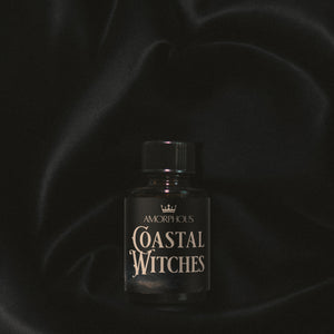 Bottle labeled 'Coastal Witches' by Amorphous on a dark background