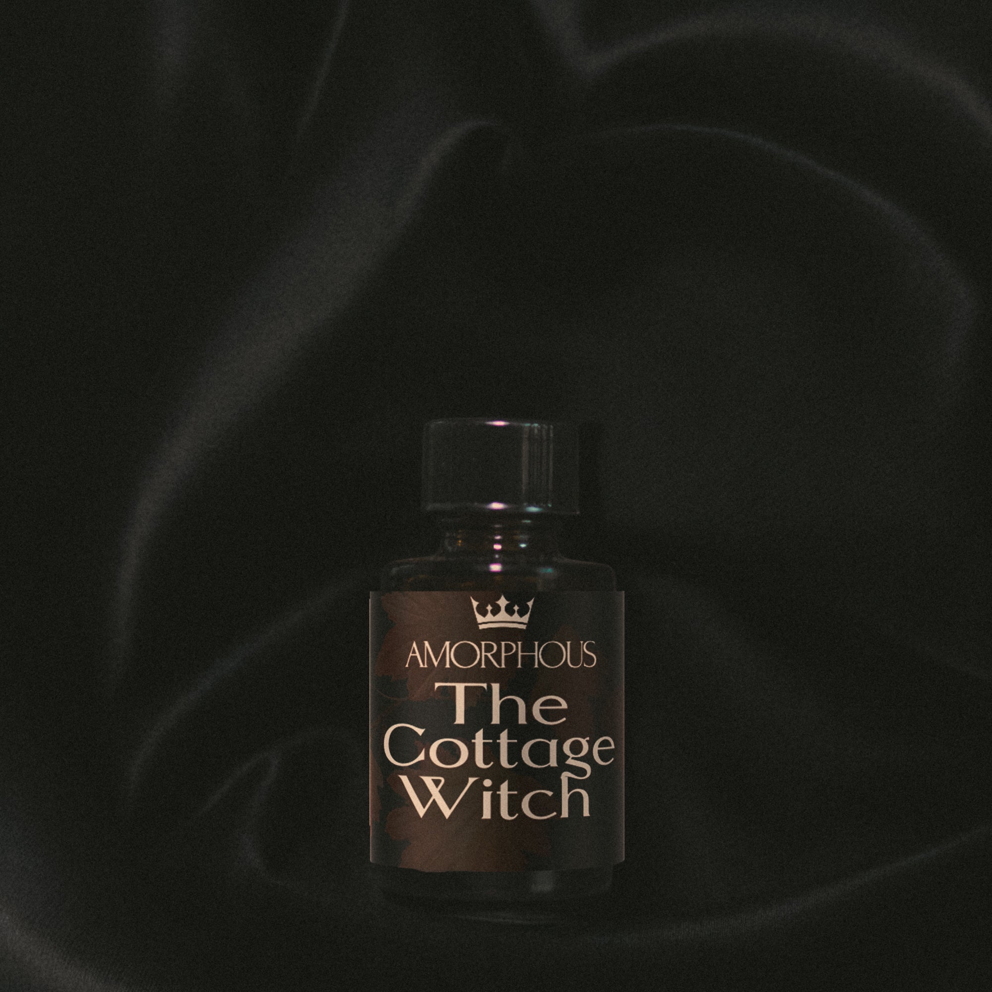 Bottle of 'The Cottage Witch' by Amorphous on a dark background
