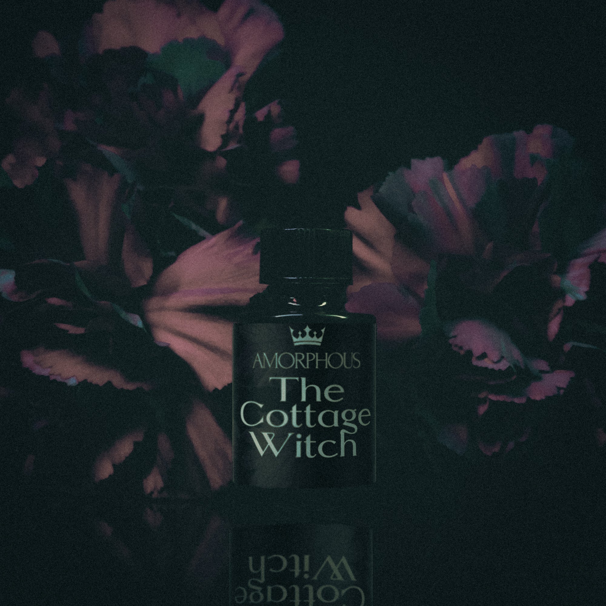 Amorphous 'The Cottage Witch' perfume bottle with floral background