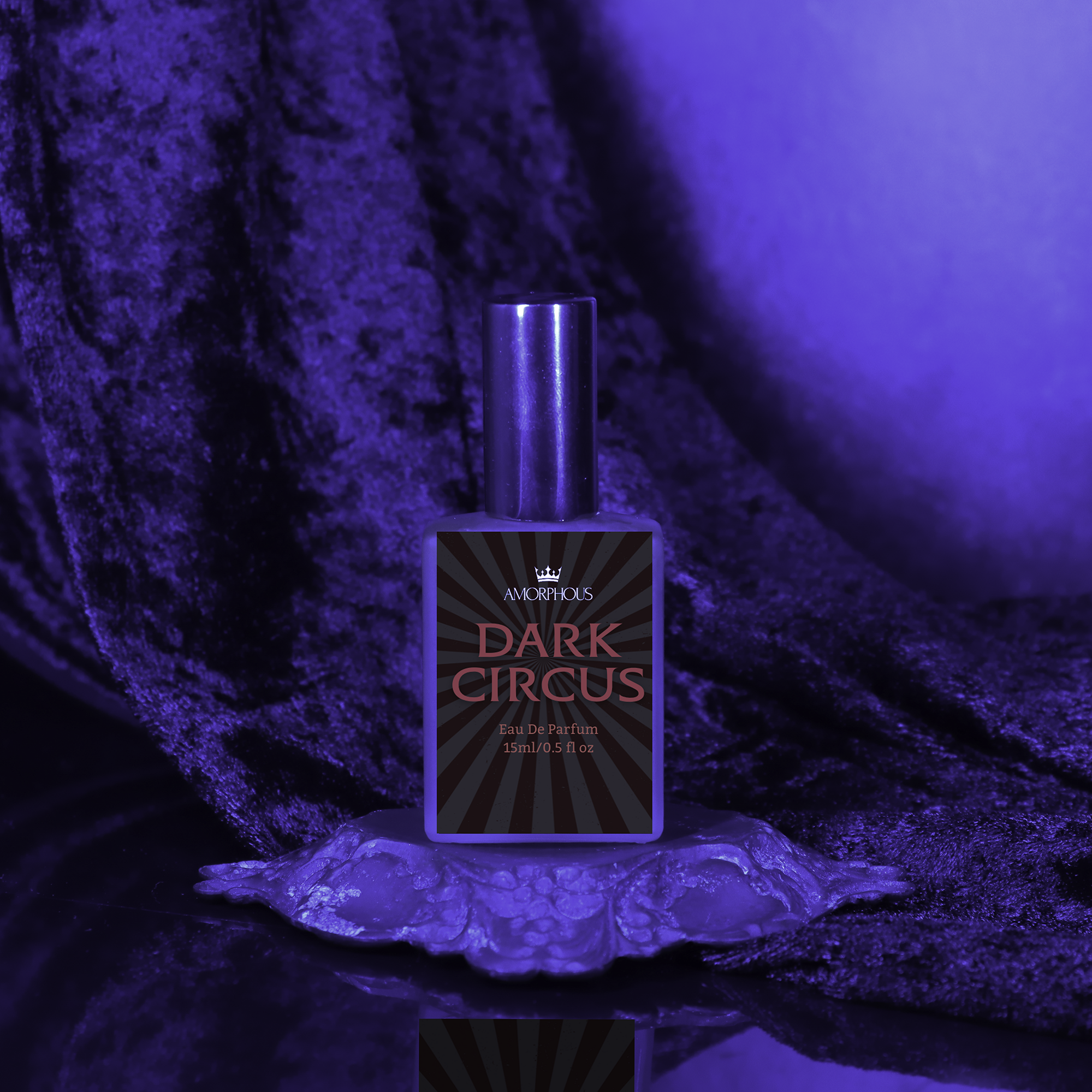 Perfume bottle labeled 'Dark Circus' on a reflective surface with purple lighting