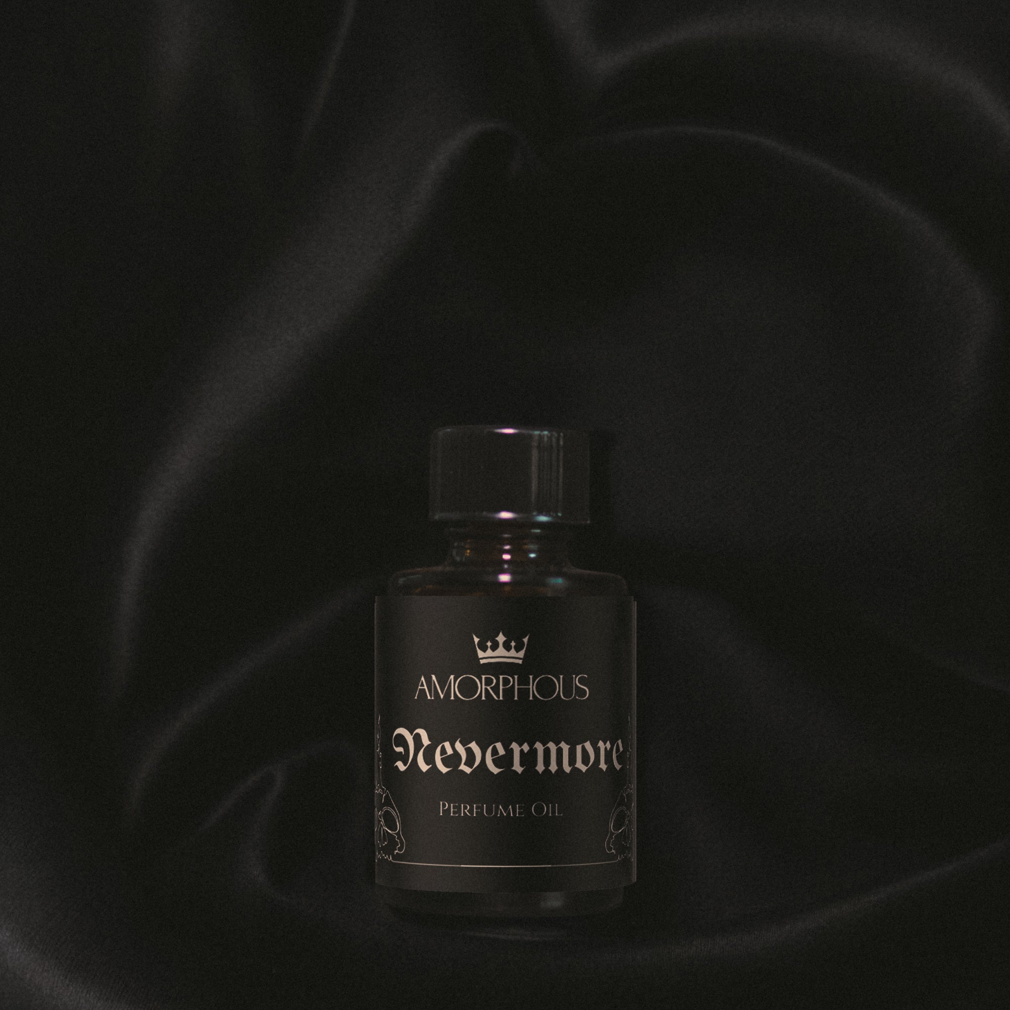 Perfume bottle labeled 'Nevermore' by 'Amorphous' on a dark background