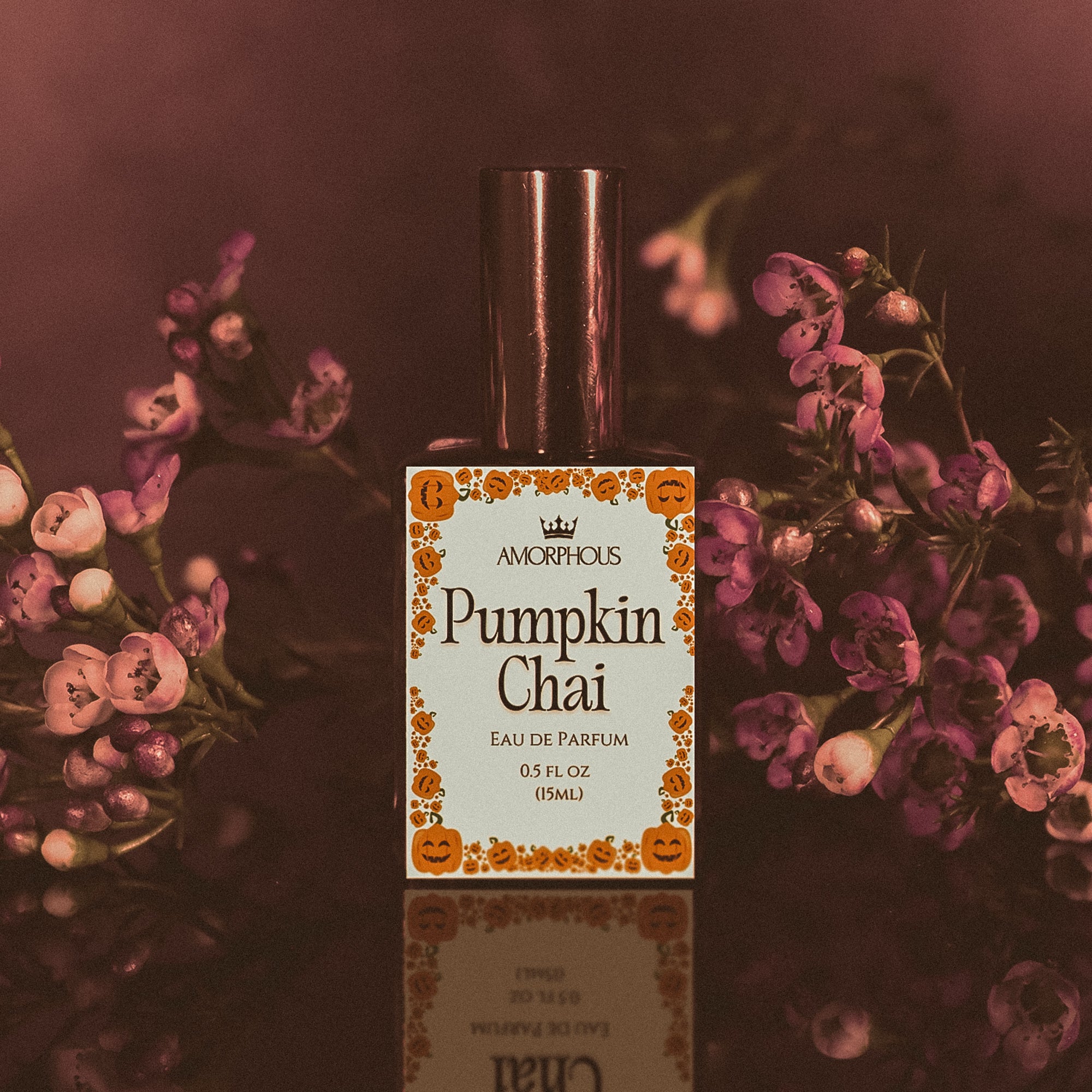Pumpkin Chai perfume bottle with floral background
