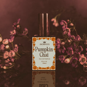 Pumpkin Chai perfume bottle with floral background