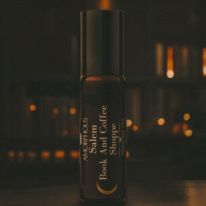 Perfume bottle labeled 'Salem Book And Coffee Shoppe' with a dark background