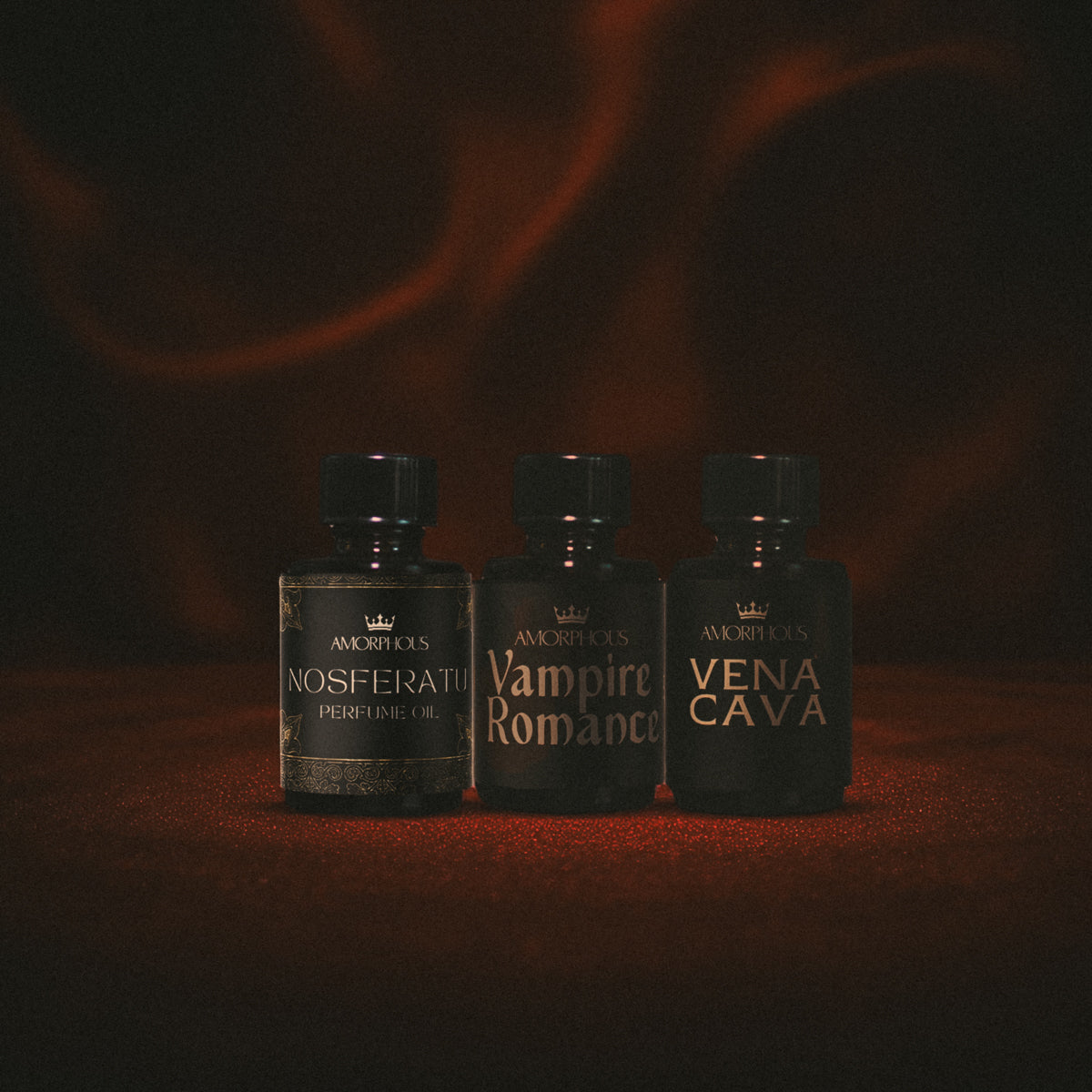 Three perfume bottles labeled 'Nosferatu', 'Vampire Romance', and 'Vena Cava' on a dark background.